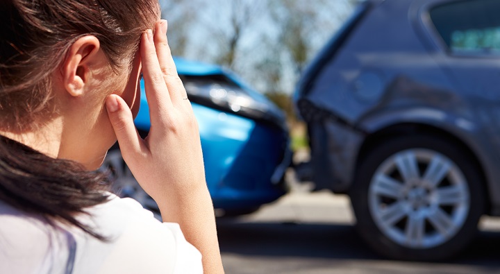 Stressed Driver Sitting At Roadside After Traffic Accident